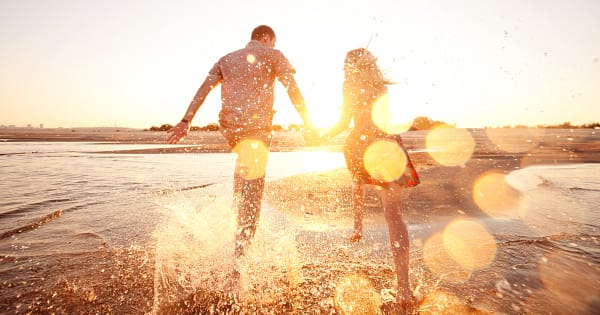 Couple running on beach (1200)
